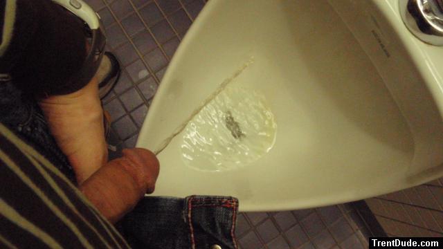 Peeing clear pee in a urinal, to show that urine may be clear after drinking large amounts of water