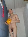 Nude water polo player in shower, hanging his swim brief from penisl  (flaccid penis, scrotum)