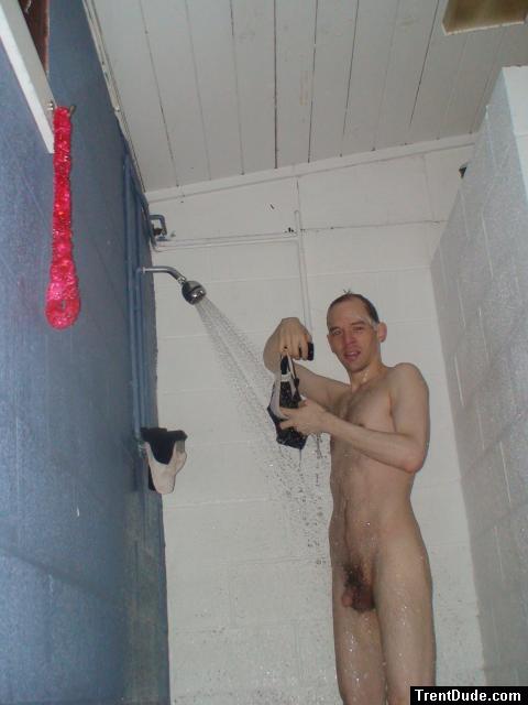 Rinsing  black/white swim brief in the shower