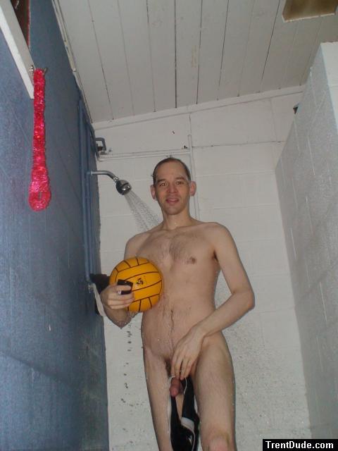 Nude water polo player in shower, hanging his swim brief