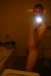 Nude in a hotel bathroom mirror, before shower
