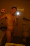 Nude in a hotel bathroom mirror, before shower
