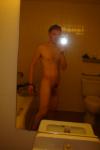 Nude in a hotel bathroom mirror, before shower