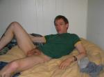 relaxing in a green shirt, penis resting on chest