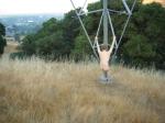 Naked outdoors  - climbing electrical tower in the mountains