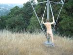 Naked outdoors  - climbing electrical tower in the mountains