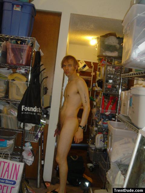 Standing nude with number tatoos on left arm