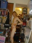 Standing nude with number tatoos, left arm