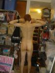 Standing nude with number tatoo on right ankle