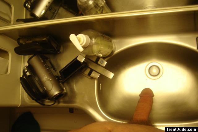 Soft penis ready for a bath in the wash tub