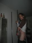 Trying to tie his penis in a knot around a pole