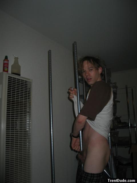 Trying to tie his penis in a knot around a pole