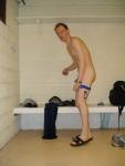 Changing into a blue speedo in the locker room