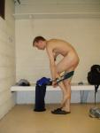 changing into a green speedo in the locker room