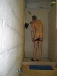 Pulling off his swim suit