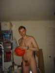 Nude while holding a basketball