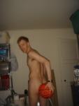 Nude while holding a basketball