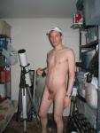 Standing nude by a telescope