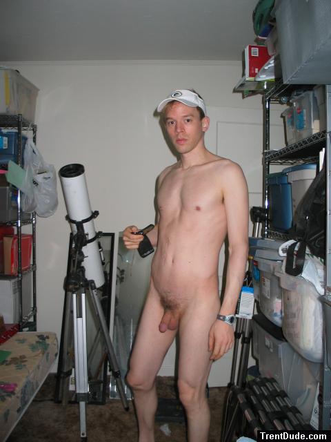 Standing nude by a telescope