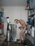 Standing nude by a telescope