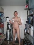 Standing nude by a telescope