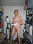 Standing nude by a telescope