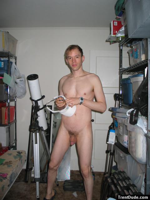 Standing nude by a telescope