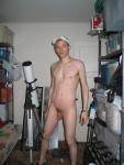 Standing nude by a telescope