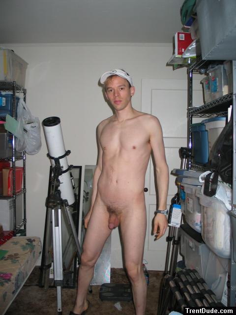 Standing nude by a telescope