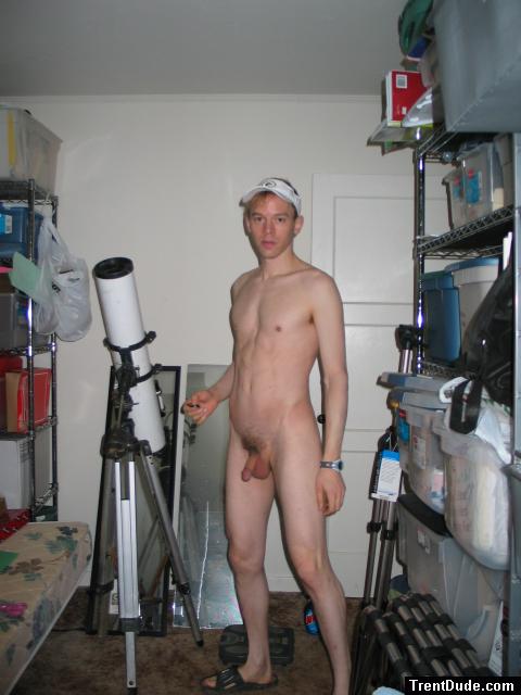 Standing nude by a telescope