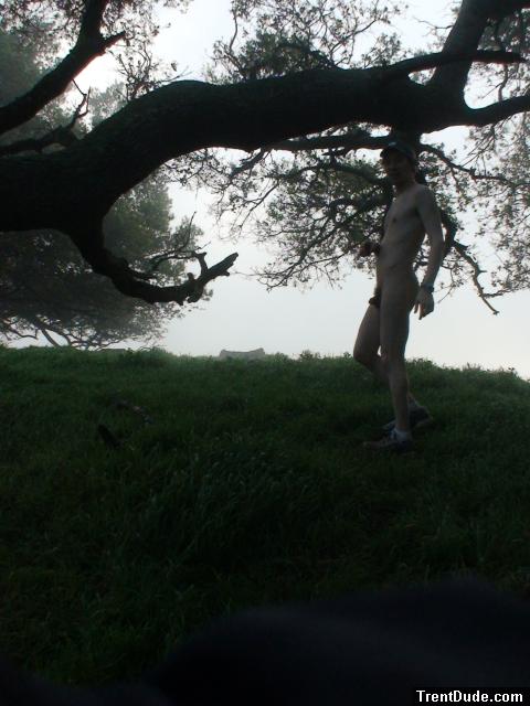 Standing nude under a tree