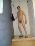 swim brief hanging from the the circumcised glans of his penis