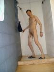 swim brief hanging from the the circumcised glans of his penis