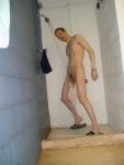 swim brief barely hanging from the the glans of his circumcised penis
