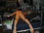 working on gluteal muscles while in bed to firm his buttocks