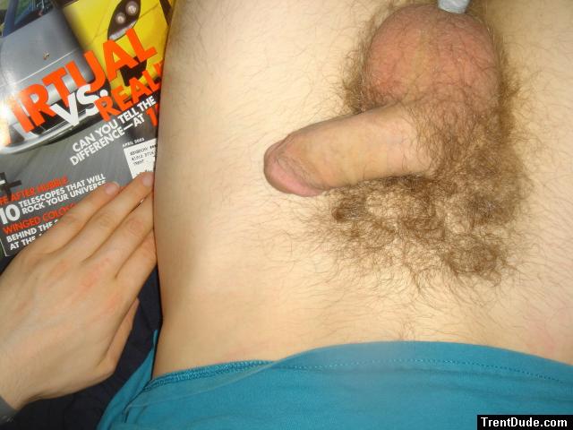 flaccid penis in bed reading a magazine